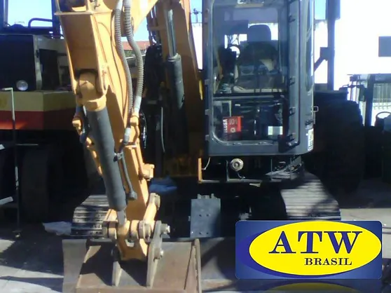 Mini escavadeira da ATW Brasil em operação em um canteiro de obras.